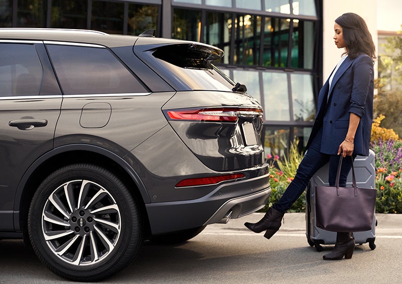 A woman with her hands full uses her foot to activate the available hands-free liftgate. | McKie Lincoln, Inc. in Rapid City SD